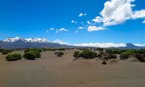 Scenic view of mountains against blue sky