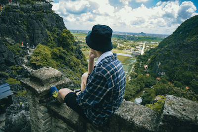 Side view of man standing on mountain