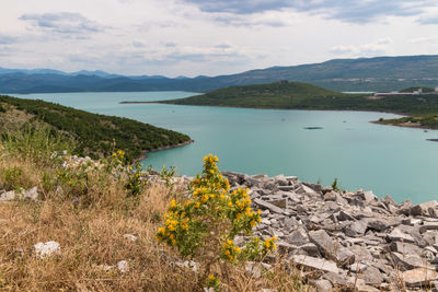 Scenic view of lake and mountains against sky