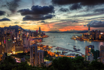 High angle view of city lit up at sunset