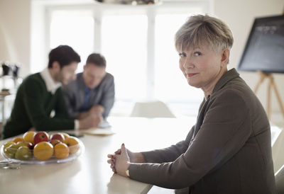 Portrait of confident businesswoman at desk in office