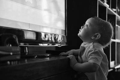 Side view of boy looking at home