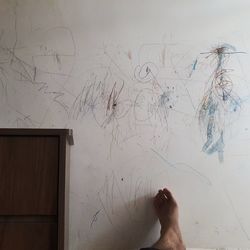Low section of woman standing on wall