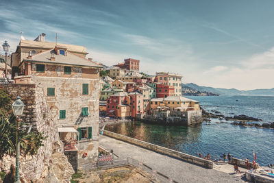 High angle view of townscape by sea against sky