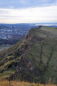 Aerial view of city by sea against sky