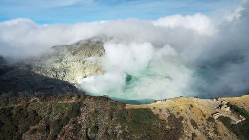 Smoke emitting from volcanic mountain against sky