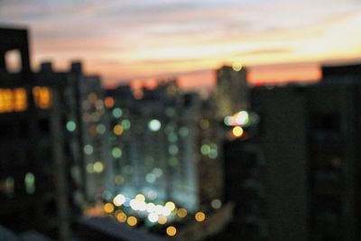 Defocused image of illuminated city at night