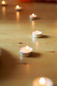 Close-up of illuminated candles on table