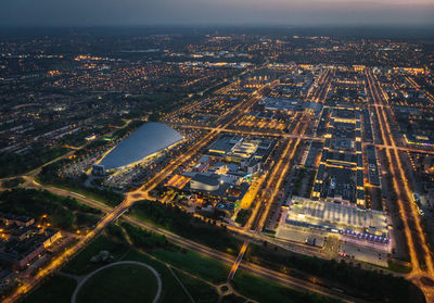 High angle view of city lit up at night