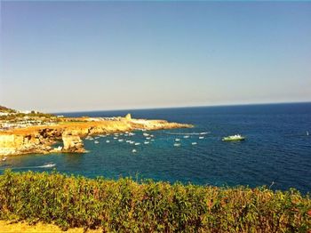 Scenic view of sea against clear blue sky