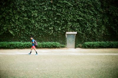 Full length of man playing soccer