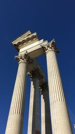 Low angle view of historical building against blue sky