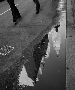 Low section of people walking on wet street