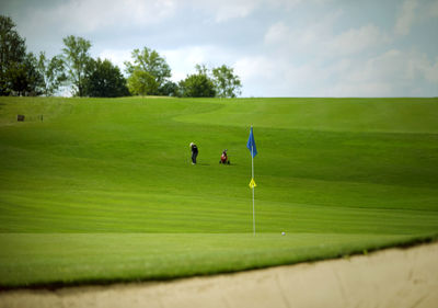 Scenic view of person playing golf on course