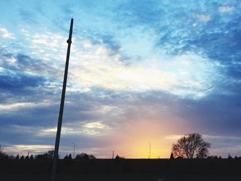 Silhouette landscape against sky at sunset