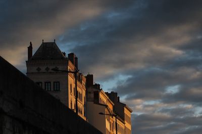 Low angle view of historic building against cloudy sky