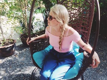 Woman sitting on swing in park