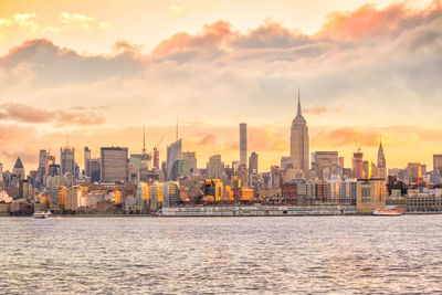 View of buildings against cloudy sky during sunset