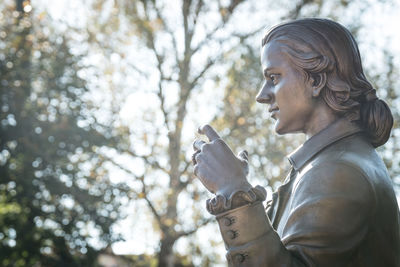 Side view of a statue of hölderlin  on backlit