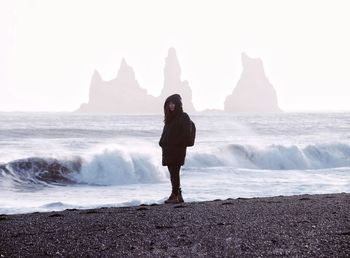 Full length of woman standing on beach