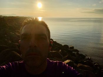 Portrait of man against sea during sunset