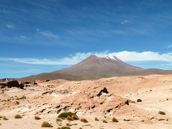 Scenic view of mountains against cloudy sky