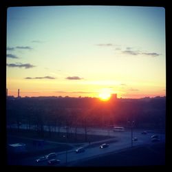 View of traffic on road at sunset