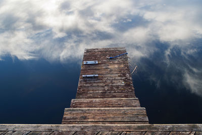 Low angle view of pier over sea against sky