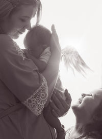 Rear view of woman holding umbrella