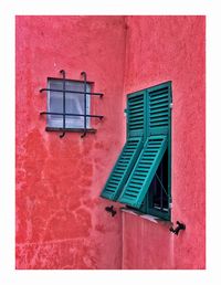 Low angle view of window on wall of building