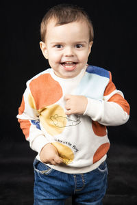 Portrait of cute boy holding camera