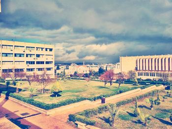 Buildings against cloudy sky