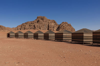 Built structure on desert against clear blue sky