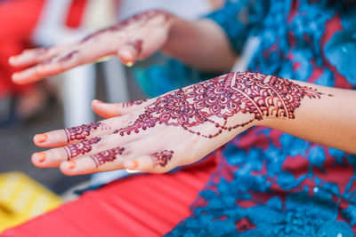 Midsection of woman with henna tattoo