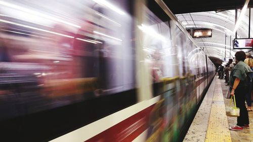 Blurred motion of train at railroad station