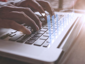 Cropped hands using laptop