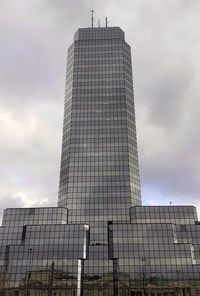 Low angle view of building against cloudy sky