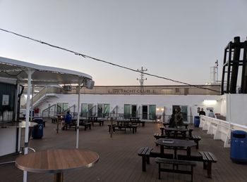 Chairs and tables against clear sky