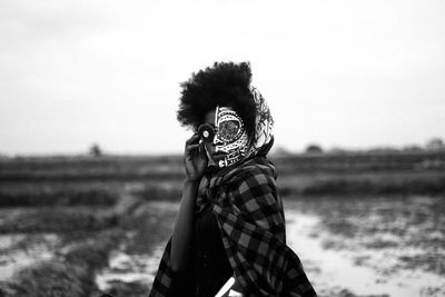 Portrait of man standing on field