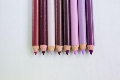 Close-up of colored pencils against white background