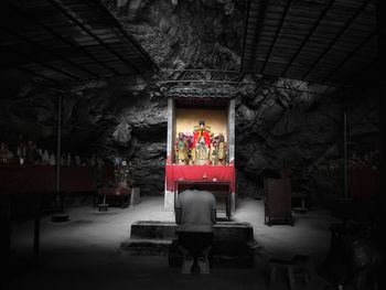 Man and woman standing by building