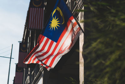 Low angle view of malaysian flag against sky