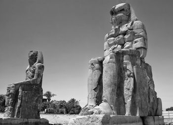 Low angle view of statue against sky - colossi of memnon