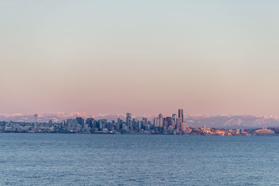 City at waterfront during sunset