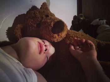 Close-up of baby sleeping on bed at home