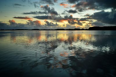 Scenic view of lake at sunset