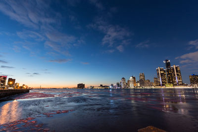 View of city at waterfront during sunset