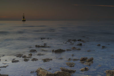 Scenic view of sea against sky at sunset