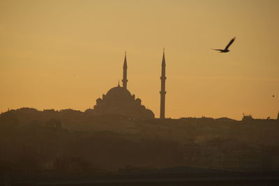 Silhouette of building against sky during sunset