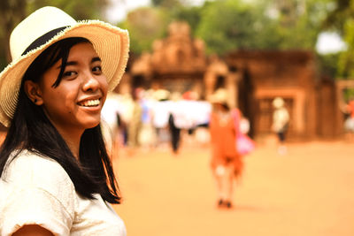 Portrait of a smiling young woman in city